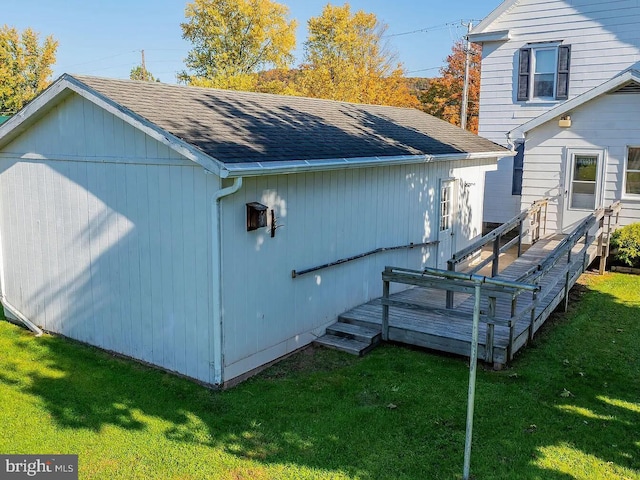 view of property exterior with a yard and a deck