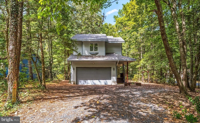 view of front property with a porch and a garage