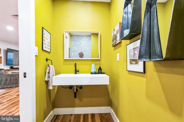 bathroom with hardwood / wood-style floors and sink