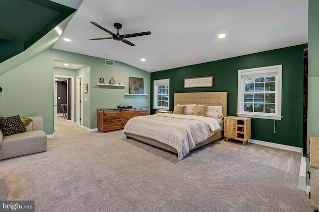 carpeted bedroom with ceiling fan and vaulted ceiling