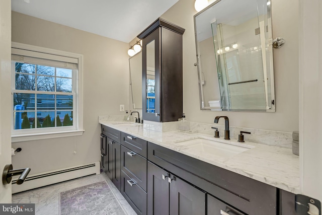 bathroom featuring vanity, a baseboard radiator, and a shower with shower door