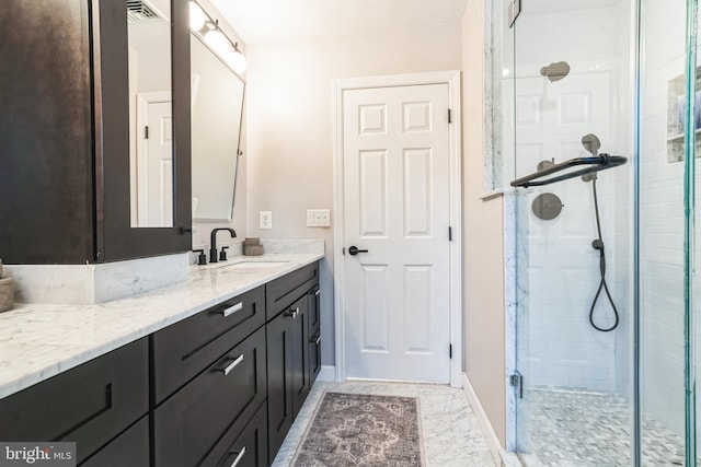 bathroom featuring vanity and a shower with shower door