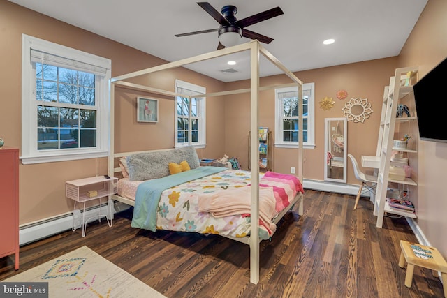 bedroom featuring baseboard heating, ceiling fan, and dark hardwood / wood-style flooring