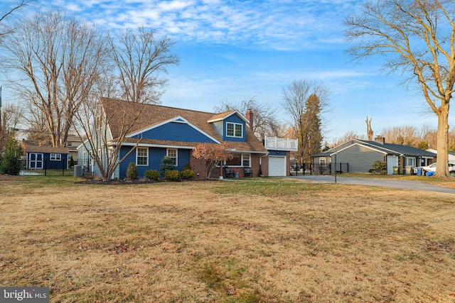 view of front of property featuring central AC, a front lawn, and a garage