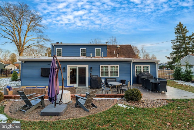 back of house featuring a lawn and a patio