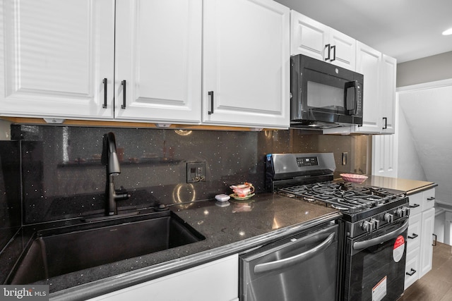 kitchen featuring tasteful backsplash, white cabinetry, sink, and stainless steel appliances