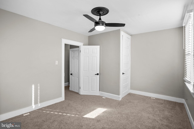 unfurnished bedroom featuring carpet flooring and ceiling fan