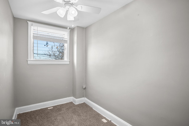 carpeted spare room featuring ceiling fan