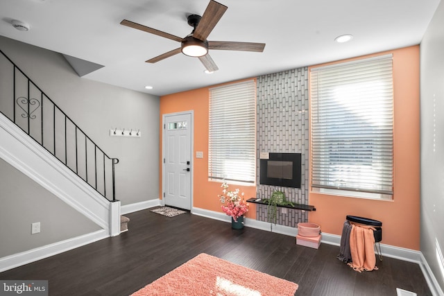 living room featuring dark hardwood / wood-style floors and ceiling fan