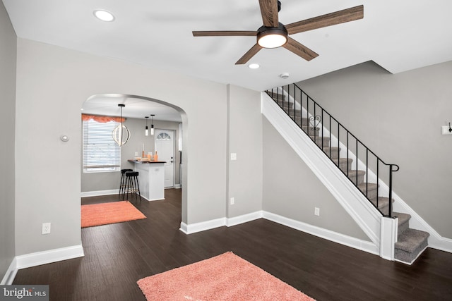 staircase featuring ceiling fan and wood-type flooring