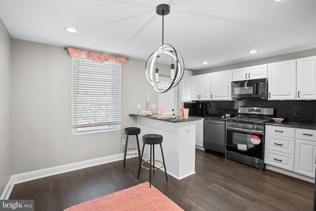 kitchen with a breakfast bar, white cabinetry, kitchen peninsula, and stainless steel appliances