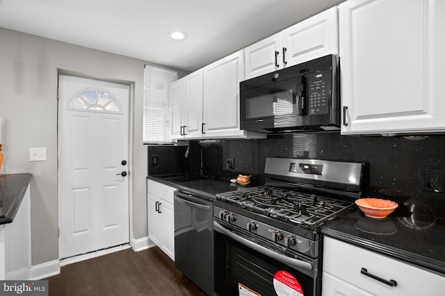 kitchen with sink, dark hardwood / wood-style flooring, backsplash, white cabinets, and appliances with stainless steel finishes