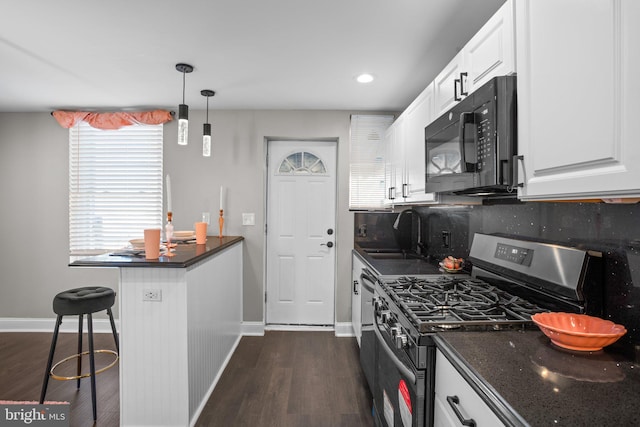 kitchen with sink, pendant lighting, white cabinetry, a breakfast bar area, and stainless steel range with gas stovetop