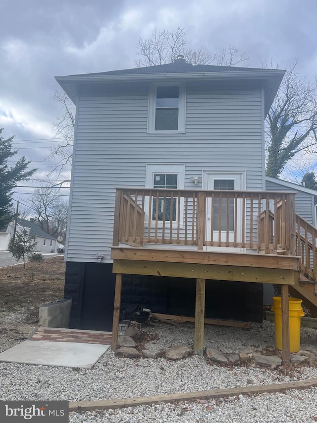 back of property featuring a wooden deck