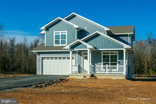 view of front of house featuring a garage and covered porch