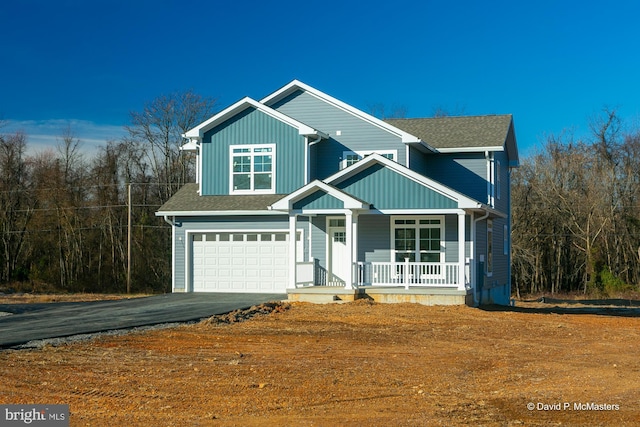 view of front of house featuring a garage and covered porch