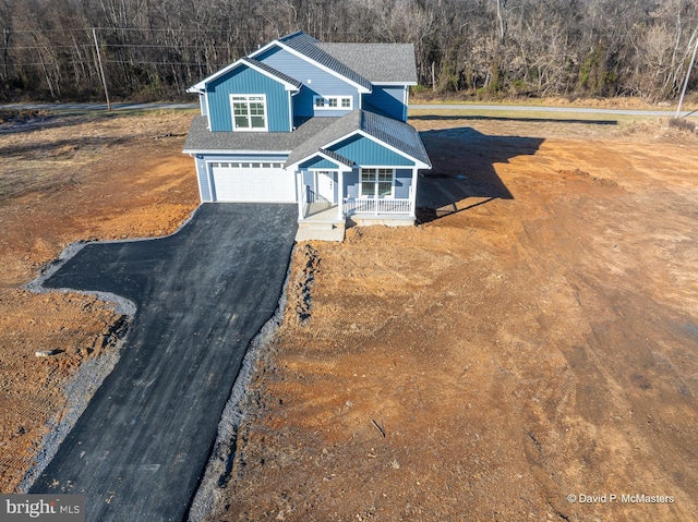 view of front of home featuring a garage and covered porch