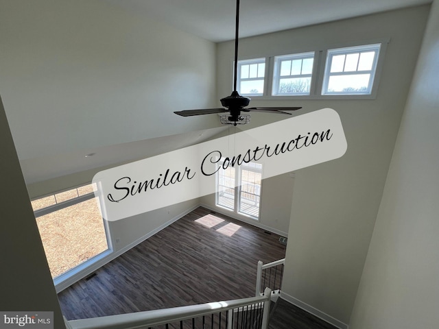 staircase with hardwood / wood-style floors and ceiling fan