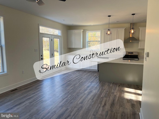 kitchen featuring stainless steel electric range oven, dark hardwood / wood-style floors, pendant lighting, and white cabinets