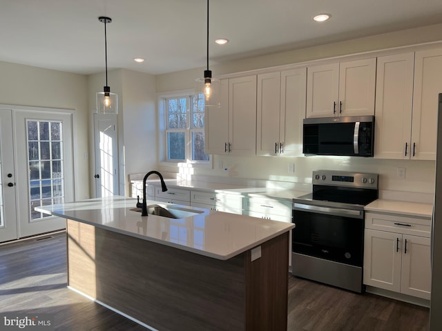 kitchen featuring appliances with stainless steel finishes, a kitchen island with sink, sink, and white cabinets