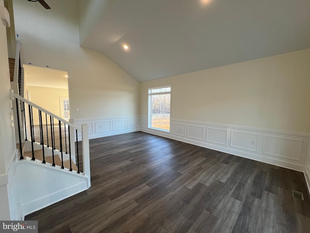 empty room featuring lofted ceiling and dark wood-type flooring