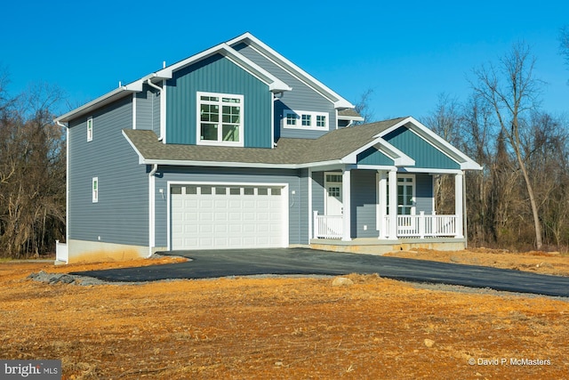 view of front of house featuring a garage and covered porch