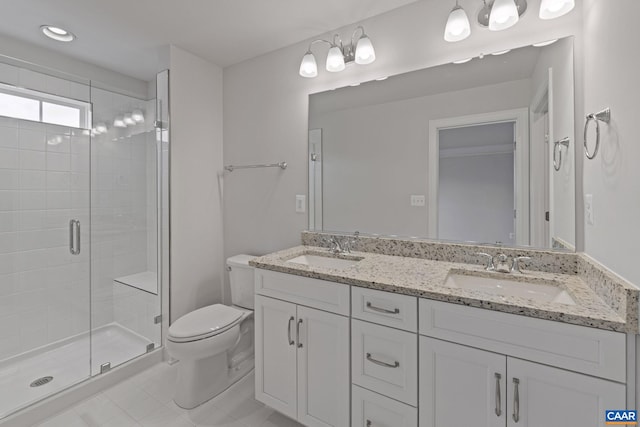 bathroom featuring tile patterned flooring, toilet, vanity, and walk in shower