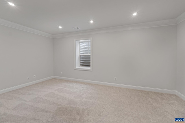 carpeted spare room with crown molding