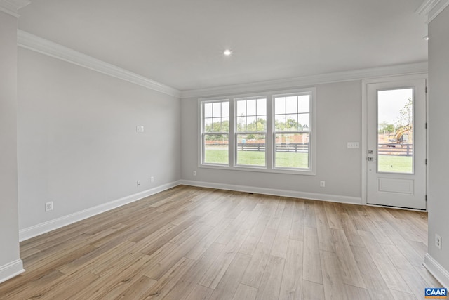 unfurnished room with light wood-type flooring and ornamental molding