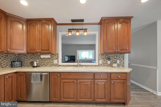 kitchen featuring brown cabinets, a sink, and stainless steel dishwasher