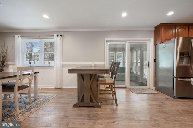 dining area featuring recessed lighting, crown molding, and light wood-style flooring