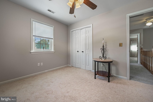 bedroom with baseboards, carpet, visible vents, and a closet