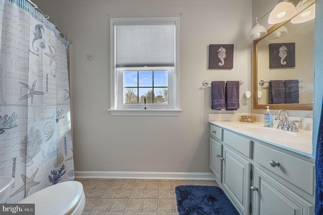 full bathroom with toilet, tile patterned floors, baseboards, and vanity