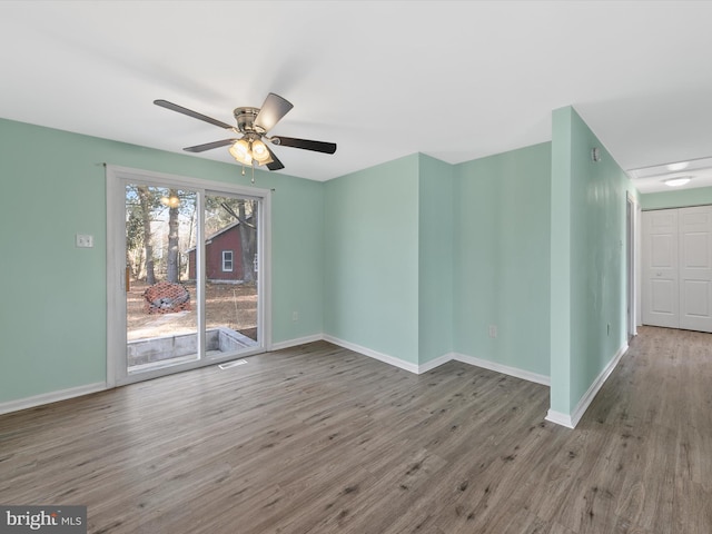 spare room featuring ceiling fan and hardwood / wood-style floors