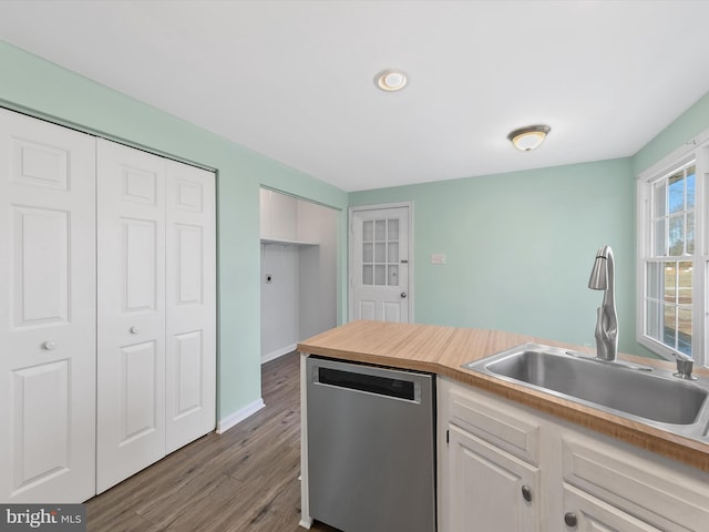 kitchen with dishwasher, white cabinets, dark wood-type flooring, and sink