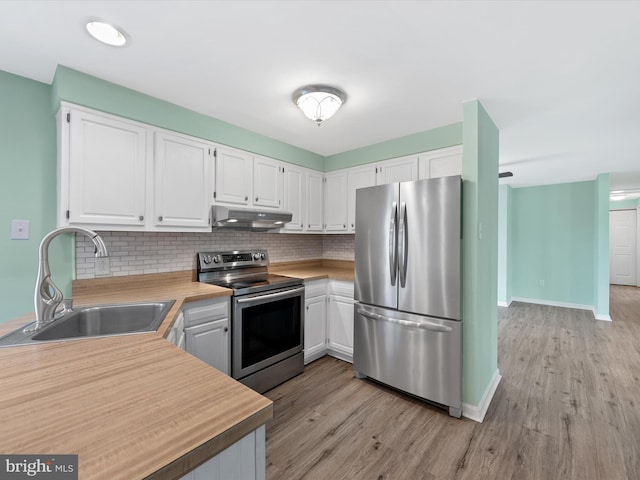 kitchen with decorative backsplash, sink, white cabinets, and stainless steel appliances