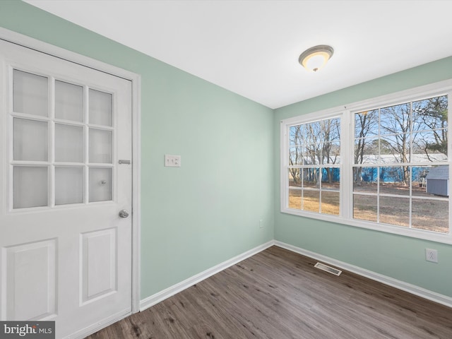 empty room featuring wood-type flooring