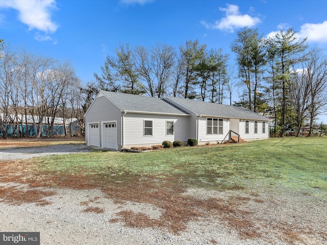 ranch-style house with a garage and a front lawn