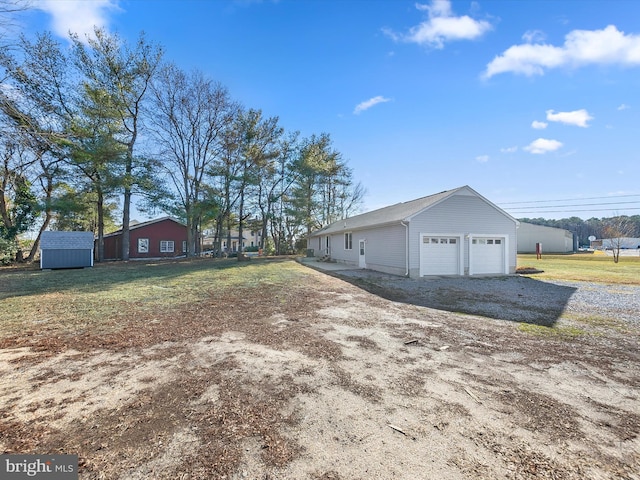 exterior space featuring a garage and a storage shed