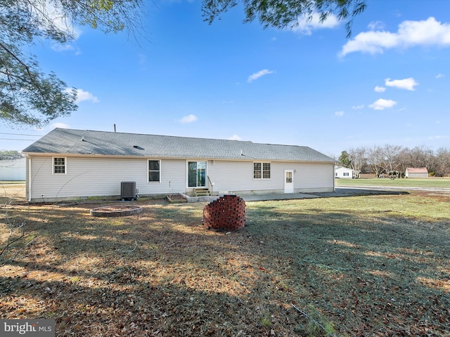 back of property with a lawn and central AC unit