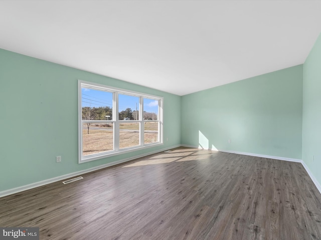 empty room with hardwood / wood-style flooring