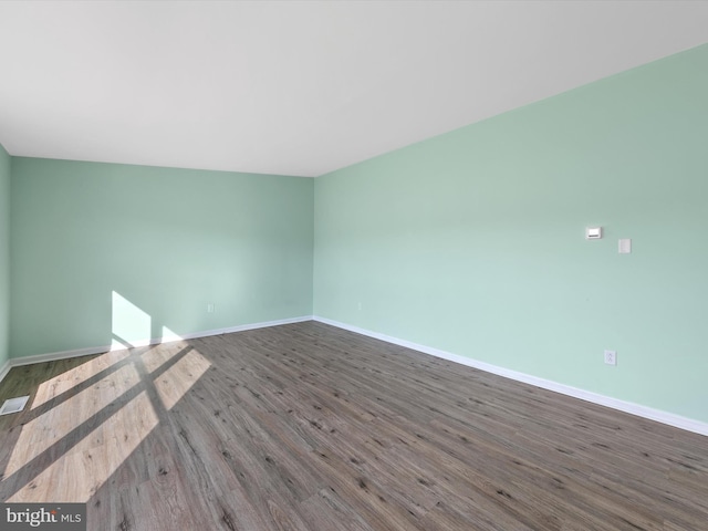 spare room with hardwood / wood-style floors