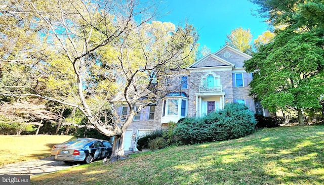 view of front of home with a front yard and a garage