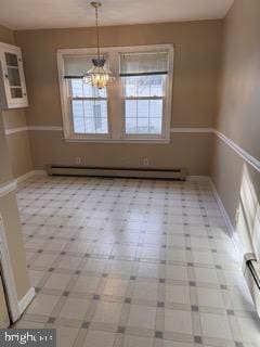 unfurnished dining area with a baseboard radiator and a notable chandelier