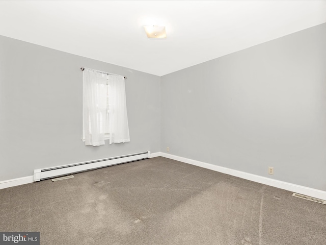 carpeted spare room with baseboard heating