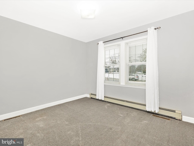 carpeted spare room with baseboard heating