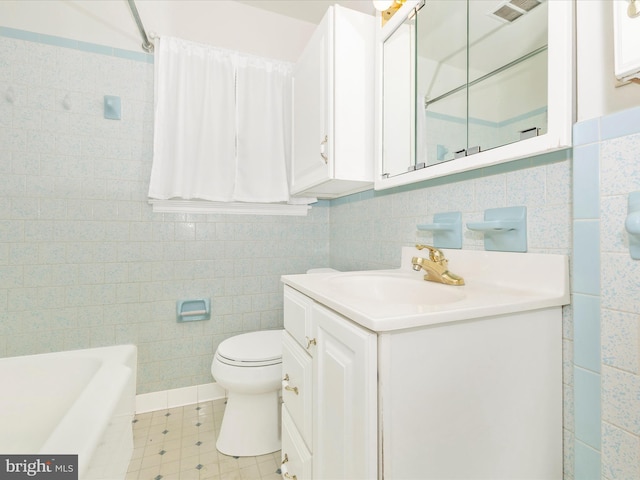 bathroom with a bathing tub, vanity, toilet, and tile walls