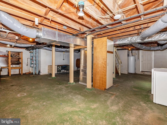 basement featuring water heater and washer / dryer