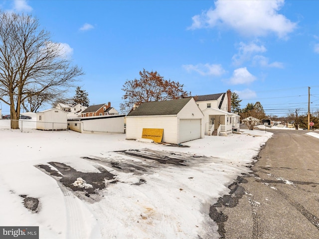 view of snowy exterior with a garage