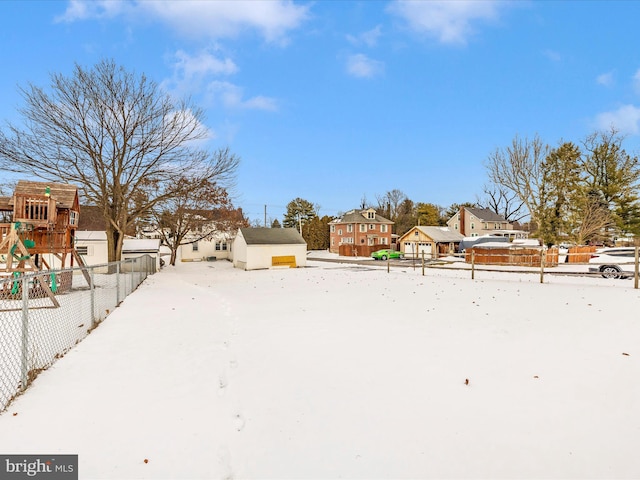 snowy yard with a playground